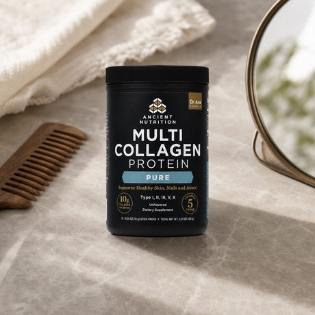 Ancient Nutrition Multi Collagen Protein Pure Powder Sticks arranged beside a prepared beverage