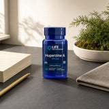Life Extension Huperzine A 200 mcg bottle displayed with capsules on a clean counter