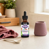 Oregon's Wild Harvest Kids Echinacea raspberry liquid bottle on kitchen counter with measuring spoon
