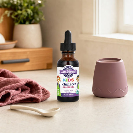 Oregon's Wild Harvest Kids Echinacea raspberry liquid bottle on kitchen counter with measuring spoon