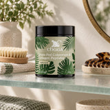 Chuga Grass-Fed Colostrum & Collagen Peptides jar on a glass bathroom shelf beside a bath brush and hair clip
