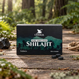 Chuga Pure Himalayan Shilajit Tablets box and three tablets on a wooden forest boardwalk