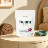 Beam Kids All-In-One Superpowder Chocolate tub beside a prepared chocolate drink