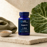 Life Extension Super K 90 softgels bottle on a kitchen counter for a daily supplement routine