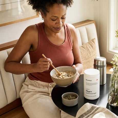 Momentous Fiber+ Powder Unflavored scoop and powder shown with a daily shake