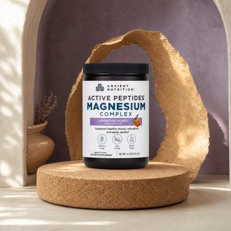 Ancient Nutrition Active Peptides Magnesium Powder Lavender Honey displayed beside a prepared cold drink
