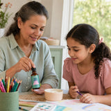 JoySpring ParaPatrol Drops lifestyle scene with bottle, dropper, and kid-friendly serving setup