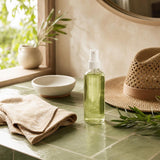 NOW Foods Bug Ban Spray 4 fl oz displayed outdoors with greenery and summer gear