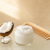 NOW Foods Coconut Oil Pure jar with coconut pieces in a body care lifestyle scene