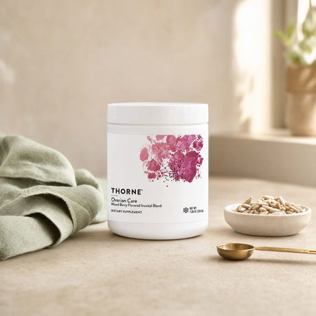 Thorne Research Ovarian Care Powder canister with mixed berry drink prepared nearby