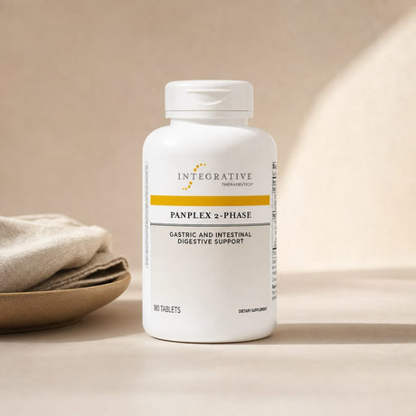 Integrative Therapeutics Panplex 2-Phase 180 tablets bottle on a kitchen counter near a meal