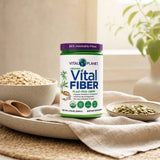 Woman adding Vital Planet Organic Vital Fiber to a smoothie in a kitchen