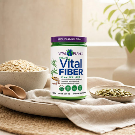 Woman adding Vital Planet Organic Vital Fiber to a smoothie in a kitchen