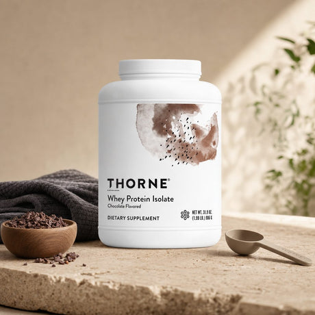 Thorne Research Whey Isolate Chocolate tub beside a prepared shake