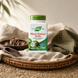 Nature's Way Black Walnut Hulls bottle with capsules on a clean tabletop