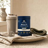 Ancient Nutrition Multi powder scoop beside shaker bottle