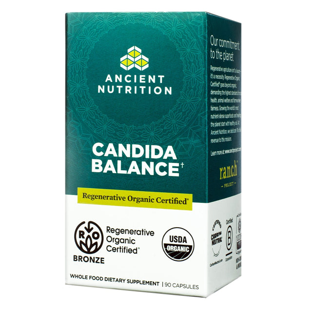 A teal-colored box labeled Candida Balance, featuring USDA Organic and Regenerative Organic Certified seals, providing 90 capsules aimed at maintaining balance in the microbiome.