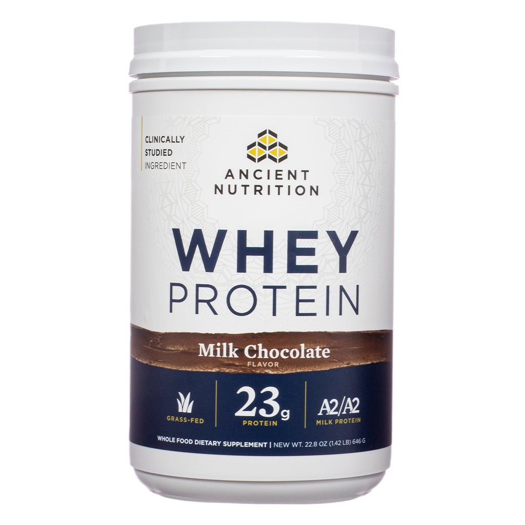 The front label of Ancient Nutrition Whey Protein Powder Milk Chocolate 22.8 oz shows the product's branding, highlighting 23g of protein per serving, A2/A2 milk protein, and grass-fed sourcing.