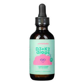 A dark amber glass bottle of JoySpring D3 + K2 liquid drops featuring a mint green label with a cheerful pink cloud illustration. The label highlights 360 servings, 1 fl. oz (30 ml) of liquid vitamin D3 + K2 (1000 IU), and is positioned as a child-friendly dietary supplement with a dropper top.