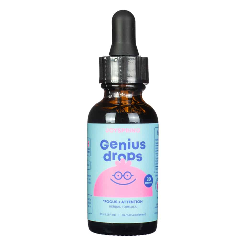 A child-friendly amber dropper bottle of JoySpring Genius Drops, featuring a light blue and pink label with a smiling brain icon wearing glasses. The label promotes focus and attention, contains 30 servings in a 1 fl. oz (30 mL) bottle, and is marketed as a herbal supplement to support kids' cognitive function.