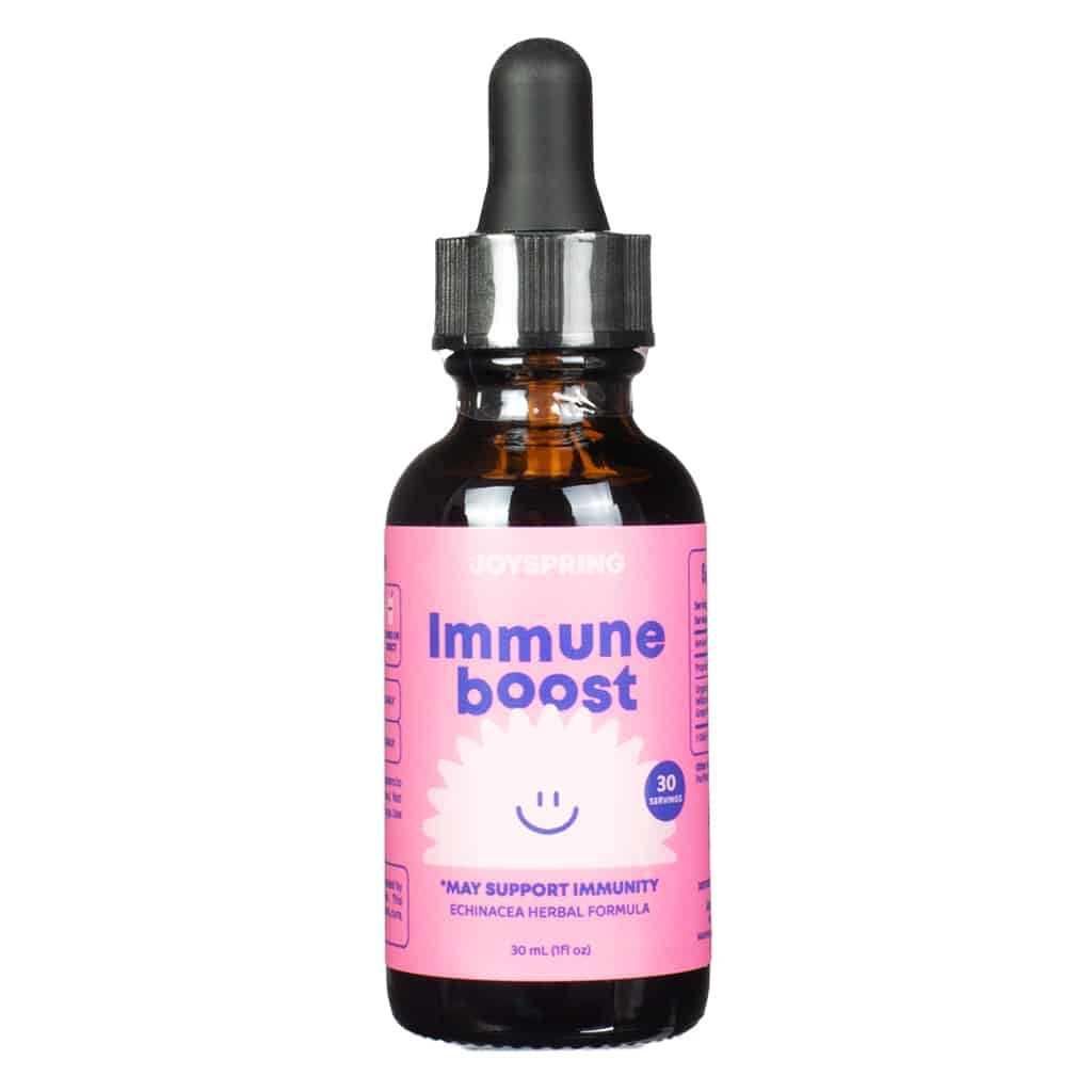 A 1 fl. oz (30 mL) amber dropper bottle of JoySpring Immune Boost, featuring a playful pink label with a smiling white flower graphic. The label highlights 30 servings and an echinacea-based herbal formula designed to help support immune health in children.