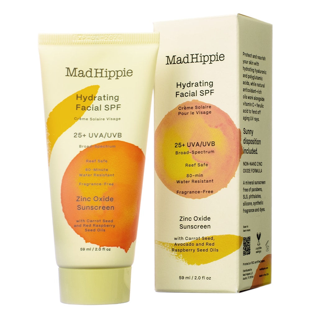 A 2 fl oz / 59 ml tube of Mad Hippie Hydrating Facial SPF next to its box, highlighting 25+ UVA/UVB broad-spectrum protection. The reef-safe, water-resistant formula features zinc oxide, carrot seed oil, avocado oil, and red raspberry seed oil for hydration and sun protection.