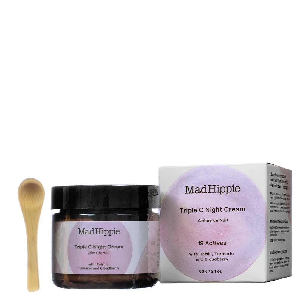 A 2.1 oz / 60 g jar of Mad Hippie Triple C Night Cream accompanied by a small wooden applicator and its box. The label mentions 19 actives, including reishi, turmeric, and cloudberry, designed for intense hydration and overnight skin repair.