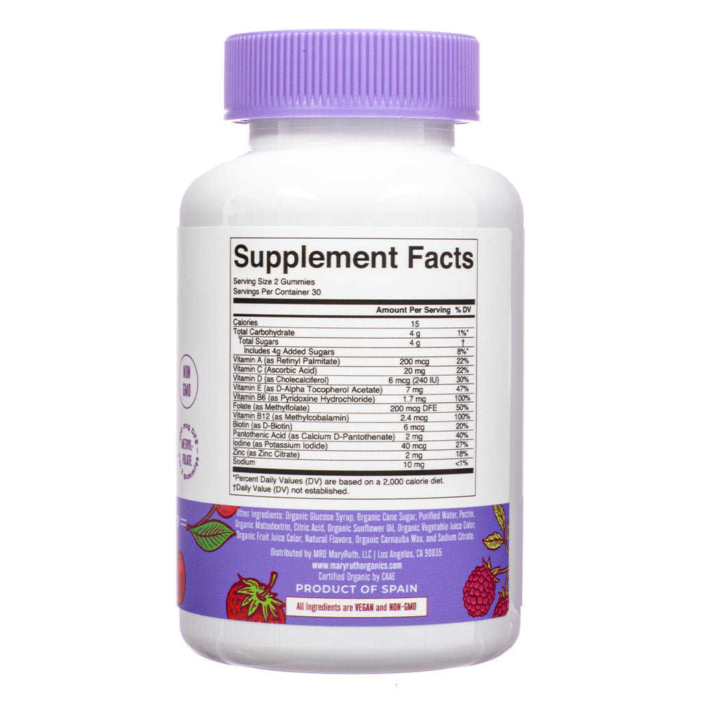 This is the back of a supplement bottle displaying the Supplement Facts label. It lists nutritional information, including vitamins, minerals, and their daily values. The bottle has a purple cap and features a vegan and non-GMO certification. The product is labeled as a "Product of Spain" and distributed by MaryRuth Organics.
