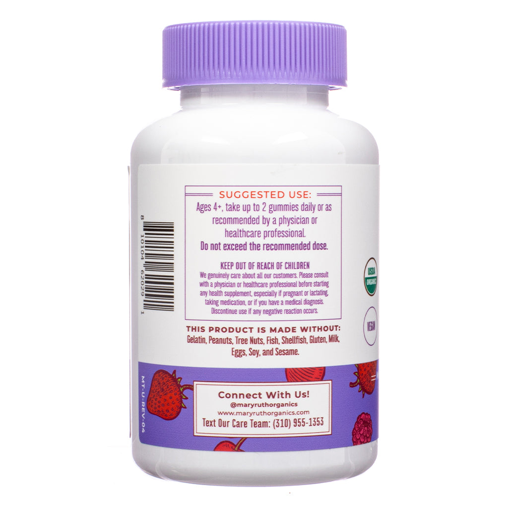 Back of a MaryRuth Organics supplement bottle with a purple cap, showing usage instructions and allergen-free claims. The label states the gummies are free from gelatin, nuts, fish, gluten, dairy, soy, and sesame. Organic and vegan certifications are visible, along with a contact number and berry illustrations.