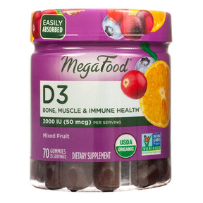A clear plastic jar with a purple lid and label showing MegaFood D3 Gummies for bone, muscle, and immune health. The label features colorful fruit images (orange, cranberry, blueberry), with “2000 IU (50 mcg) per serving” noted, USDA Organic and Non-GMO Project Verified seals, and states 70 gummies for 35 servings.
