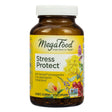 A brown bottle of MegaFood Stress Protect dietary supplement with a white cap and yellow label featuring botanical illustrations of ashwagandha, lavender, and berries. The product highlights 60 tablets per bottle and contains Sensoril® ashwagandha with an adaptogenic herbal blend to support stress response and emotional well-being.