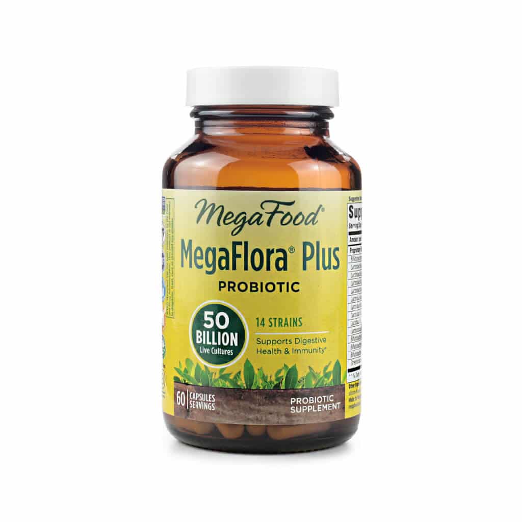 Bottle of MegaFood MegaFlora Plus Probiotic containing 60 capsules with 50 billion live cultures per serving. The label highlights 14 strains that support digestive health and immunity, with imagery of leafy greens and a bright yellow background.