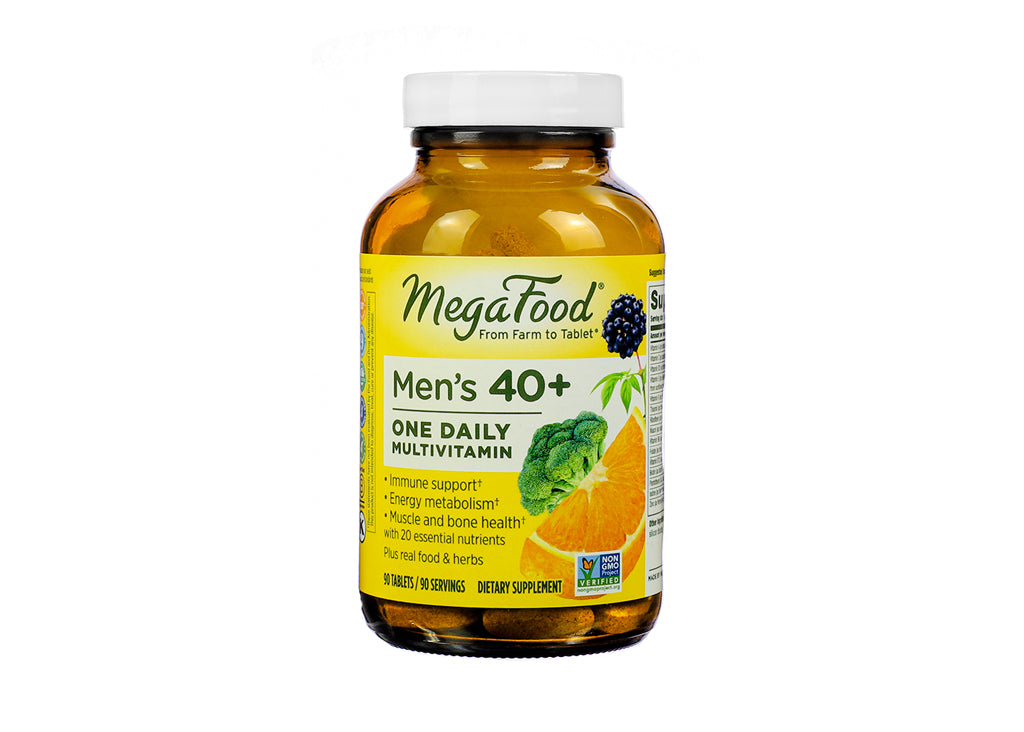 A bottle of MegaFood Men’s 40+ One Daily Multivitamin, containing 90 tablets. The label promotes benefits for immune support, energy metabolism, and muscle and bone health, with 20 essential nutrients. Brightly colored label includes images of orange slices, broccoli, and elderberries.