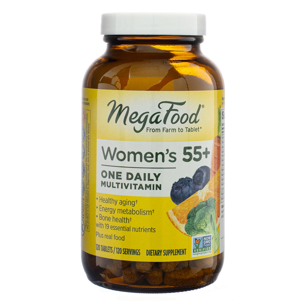 The front view of MegaFood Women's 55+ One Daily Multivitamin, 120 Tablets, in an amber glass bottle with a white cap. The yellow and white label features the MegaFood logo, images of real food ingredients like oranges and blueberries, and key benefits such as healthy aging, energy metabolism, and bone health. The product is Non-GMO Project Verified.
