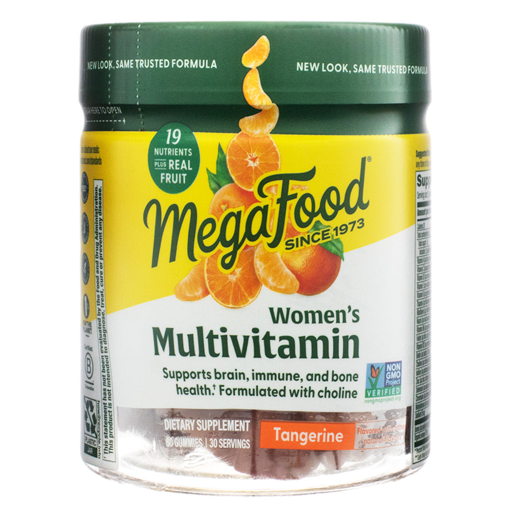 The front view of MegaFood Women’s Multivitamin Gummies, 60-count, Tangerine flavor, in a clear plastic jar with a green lid. The label features an image of fresh tangerines and highlights "19 nutrients plus real fruit." The product supports brain, immune, and bone health and is Non-GMO Project Verified.