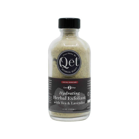A 4 oz glass bottle of Qēt Botanical Beauty Hydrating Herbal Exfoliant, labeled as Core Step 2 in a facial skincare routine. The product features tea and lavender for gentle exfoliation and hydration, with a natural powdery texture visible through the clear bottle.
