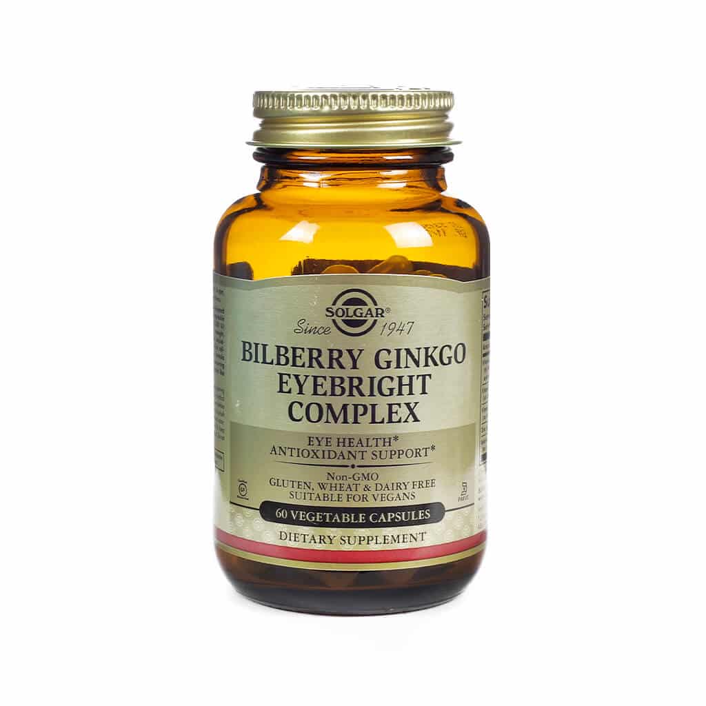 A glass bottle of Solgar Bilberry Ginkgo Eyebright Complex with 60 vegetable capsules. The product is non-GMO, vegan, and designed for antioxidant support and eye health.