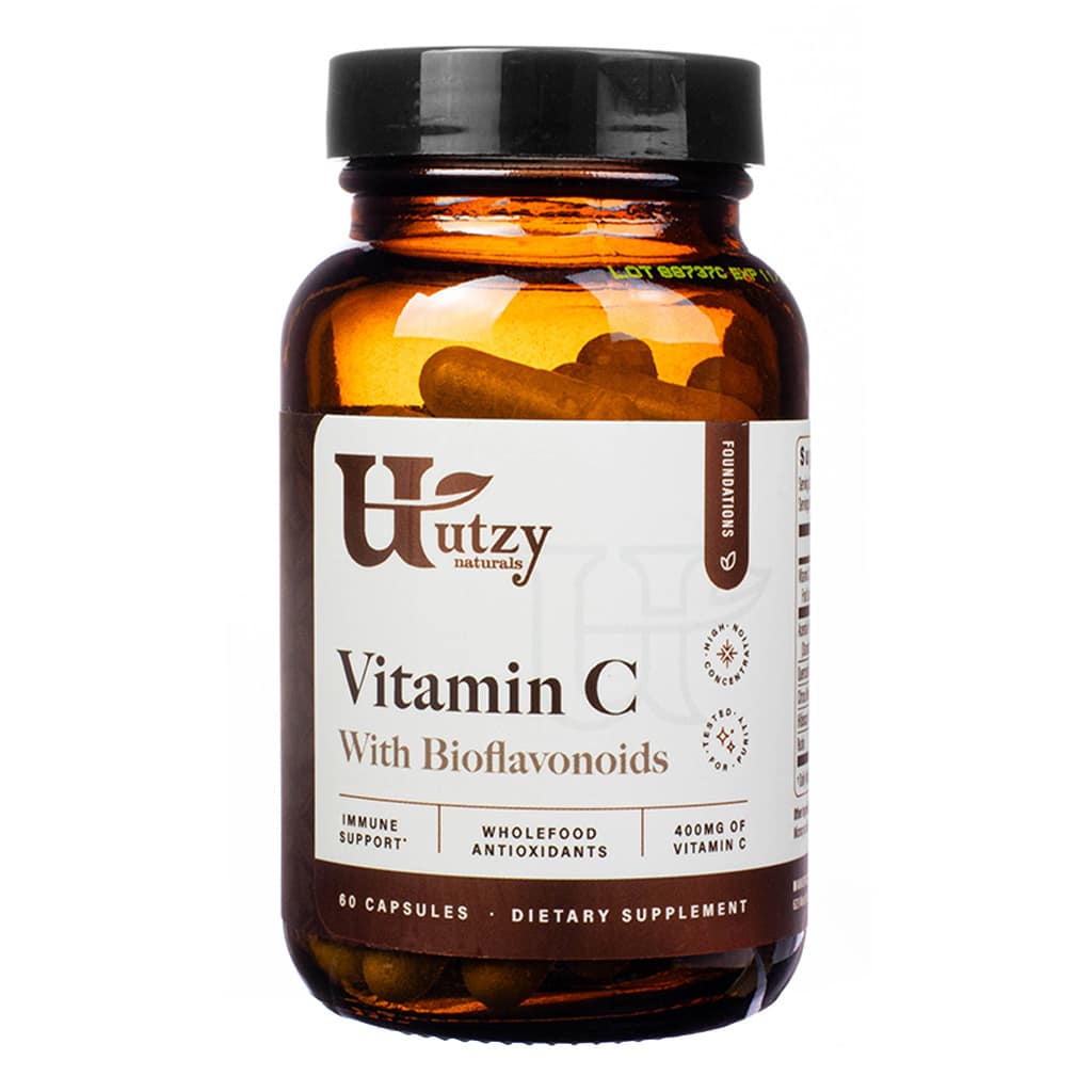 An image of a bottle of Utzy Naturals Vitamin C with Bioflavonoids dietary supplement. The brown glass bottle contains 60 capsules and is labeled to provide immune support, wholefood antioxidants, and 400mg of Vitamin C per serving. The design includes the brand's logo and detailed product descriptions.