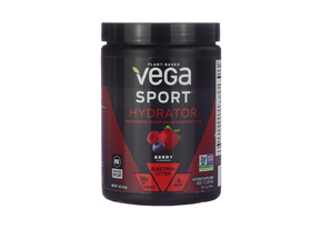 Black container of Vega Sport Hydrator, 5oz, berry flavored, with images of raspberries, strawberries, and blueberries on the label. The packaging emphasizes plant-based ingredients, zero sugar, 100% daily value of vitamin C, and electrolytes to replenish hydration, and it includes NSF Certified Sport and Non-GMO Project Verified seals.