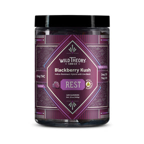Wild Theory Blackberry Kush REST 10mg THC Gummies 120 Gummies, front label view. The jar features a deep purple geometric design with the Wild Theory CBD Co. logo and “Blackberry Kush – Indica-Dominant Hybrid with Live Resin.” It highlights 10 mg THC per gummy, 2 mg CBD, and 7 mg CBN, with a central “REST” label indicating relaxation support. The label shows 120 gummies, blackberry imagery, and an extra strength symbol.
