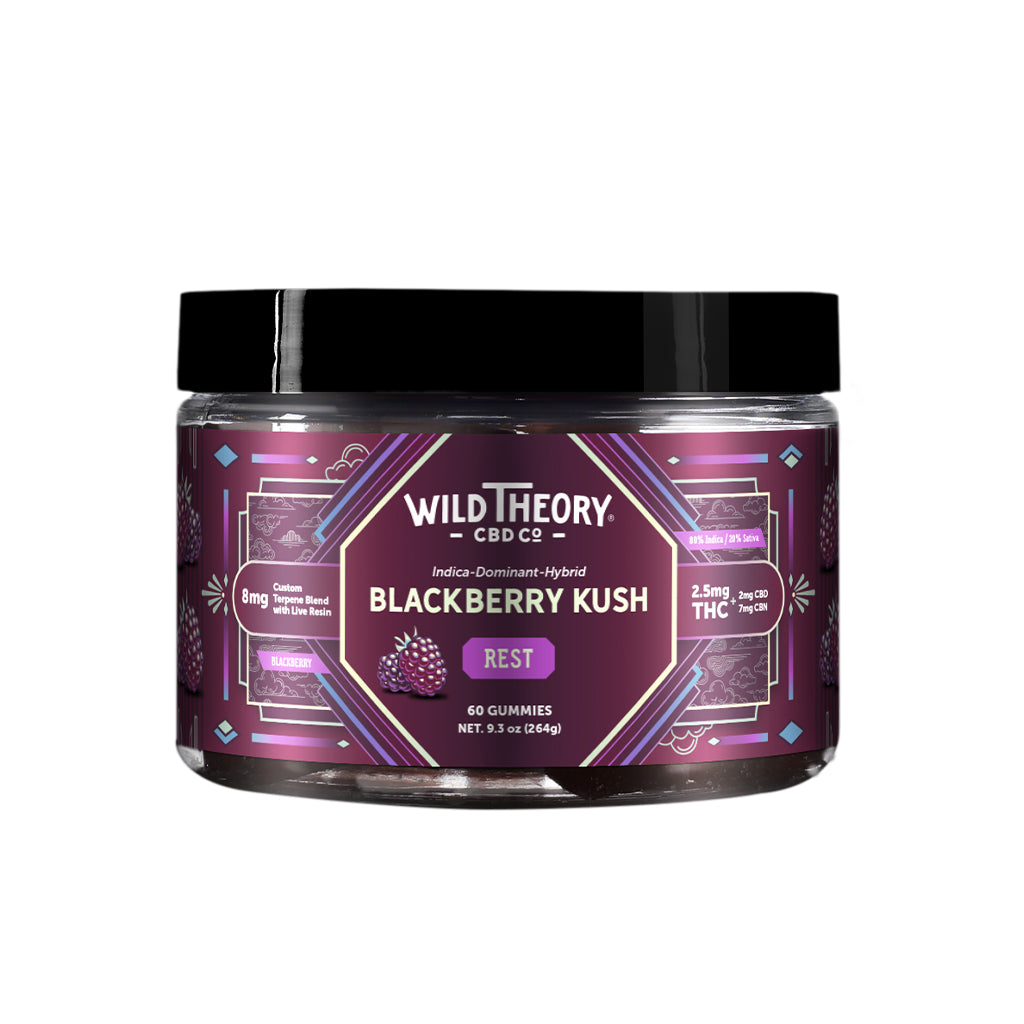 A jar of Wild Theory CBD Co. REST Blackberry Kush gummies with a deep purple label decorated with geometric designs. The Wild Theory CBD Co. logo is positioned at the top, with "Indica-Dominant Hybrid" and the product name "Blackberry Kush" below. The label highlights "REST" in a purple box and states "8mg Custom Terpene Blend with Live Resin." The dosage information indicates "2.5mg THC (2mg CBD, 7mg CBN)" per serving. The container holds "60 Gummies" and has a net weight of "9.3 oz (264g)." Additional ico