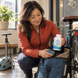 Nordic Naturals Ultimate Omega + CoQ10 Lemon bottle being packed into a bike bag by a woman