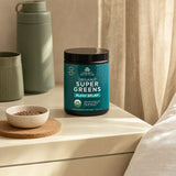 Ancient Nutrition SuperGreens Bloat Relief powder with lifestyle benefits icons