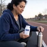 Pure Encapsulations L-Carnosine bottle displayed with capsules on a wellness counter