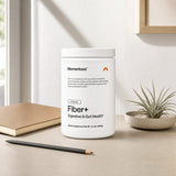 Momentous Fiber+ Powder Unflavored beside a mixed drink on a kitchen counter