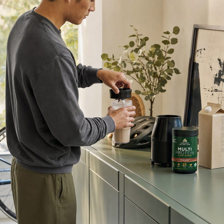 Ancient Nutrition Multi Protein Chocolate powder tub on a kitchen counter
