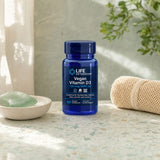 Life Extension Vegan Vitamin D3 bottle with vegan capsules beside a glass of water on a kitchen counter