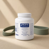 Pure Encapsulations Potassium Magnesium bottle on kitchen counter with capsules and water glass