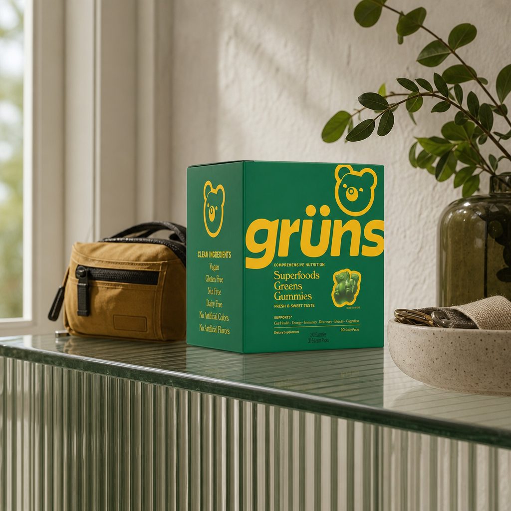 Woman holding Grüns Adult Superfood Greens Gummies Original Low Sugar daily pack