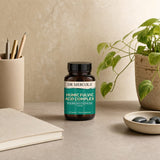 Dr. Mercola Humic Fulvic Acid Complex Capsules bottle with capsules on a kitchen counter